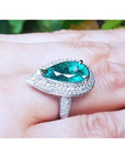Pear-shaped 3.35 ct. emerald engagement ring in 14K white gold with diamond halo.