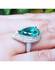Pear-shaped 3.35 ct. emerald engagement ring in 14K white gold with diamond halo.