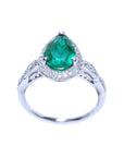 Pear cut emerald ring top and lateral gallery profile view on a white background.