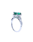 1.43 ct teardrop emerald engagement ring in 14K white gold with diamond halo and twisted band.