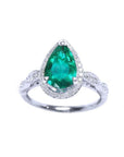 A teardrop natural colombian emerald surrounded by a halo of natural diamonds and made of 14k white gold.