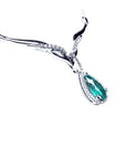 A 14k white gold women's emerald necklace pear cut encircled by a halo natural diamond.