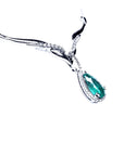 A 14k white gold women's emerald necklace pear cut encircled by a halo natural diamond.