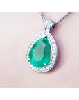 8.64 ct. pear-shaped emerald pendant with diamond halo in 14K white gold.