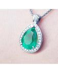 8.64 ct. pear-shaped emerald pendant with diamond halo in 14K white gold.