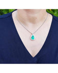 Pear-shaped 8.64 ct. Colombian emerald pendant with halo diamonds on a 14K white gold chain.