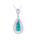 Teardrop-shaped emerald pendant with double halo diamond accents on a white background topside view.