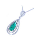 2.13 ct. teardrop emerald pendant with double diamond halo in 18K white gold.