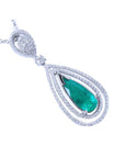 A teardrop emerald in a double halo diamonds set in 18k white gold, topside view.