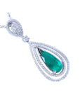 A teardrop emerald in a double halo diamonds set in 18k white gold, topside view.