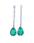 Pair of emerald teardrop earrings with diamonds accents on a white background