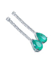 Pair of teardrop natural emerald earrings and diamond-studded clasps on a white background