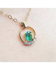 14k yellow gold necklace with oval natural Colombian emerald and diamond accents.