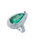 Toma cercana de una esmeralda corte lagrima con diamantes en oro blanco anillo para dama.