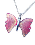 Butterfly-shaped agate pendant on a silver chain left side profile against a white background