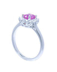 14K white gold ring with oval pink sapphire and diamond halo.