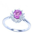 14K white gold ring with an oval pink sapphire and diamond halo.