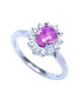 14K white gold ring with oval pink sapphire and diamond halo.