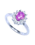 14K white gold ring with oval pink sapphire and diamond halo.