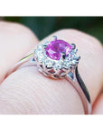 14K white gold ring with oval pink sapphire and diamond halo.