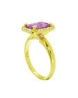 Emerald-cut pink sapphire ring with diamond halo in 14K yellow gold.