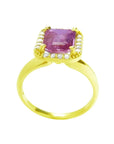Emerald-cut pink sapphire ring with diamond halo in 14K yellow gold.