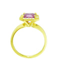 Emerald-cut pink sapphire ring with diamond halo in 14K yellow gold.