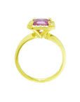Emerald-cut pink sapphire ring with diamond halo in 14K yellow gold.