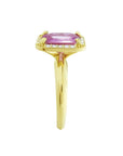 Emerald-cut pink sapphire ring with diamond halo in 14K yellow gold.