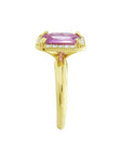 Emerald-cut pink sapphire ring with diamond halo in 14K yellow gold.