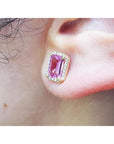 Natural pink sapphire stud earrings halo diamonds 14k yellow gold, worn on an ear lifestyle