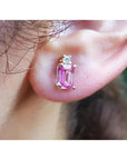 14K yellow gold stud earring with a rectangular pink sapphire and a round diamond.
