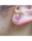 1.51 carat rectangular pink sapphire stud earrings with natural diamonds in 14K yellow gold on an ear.