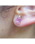 1.51 carat rectangular pink sapphire stud earrings with natural diamonds in 14K yellow gold on an ear.