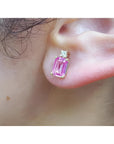 1.51 carat rectangular pink sapphire stud earrings with natural diamonds in 14K yellow gold on an ear.