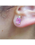 1.51 carat rectangular pink sapphire stud earrings with natural diamonds in 14K yellow gold on an ear.