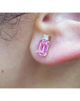 Genuine Pink sapphire stud earrings rectangular emerald cut medium pink color, very brilliant, natural diamonds on top, worn on an ear.