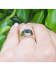 Men's 14k yellow gold pinky ring with a bezel-set, rectangular medium dark blue sapphire.