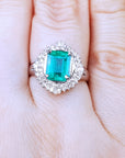 Ring with a natural colombian emerald on a hand.