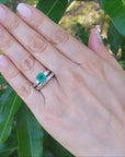 Colombian emerald engagement ring with a matching diamond wedding band.