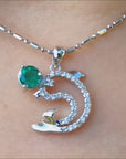 Natural emerald and diamond dolphin pendant necklace white gold.