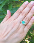 Round cut three stone emerald ring for women