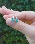 1.10 ct. Emerald and baguette diamond stud earrings