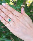 Emerald engagement ring three stone side princess cut diamonds