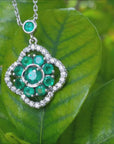 Emerald cluster necklace white gold and diamonds on leaves