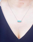 Emerald necklace for ladies 3.48 carats east west orientation encircle by halo diamonds crafted in 18k white gold