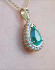 Teardrop colombian emerald pendant with halo diamond in yellow gold