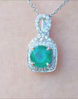 white gold pendant with a round cut natural colombian emerald.