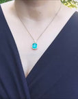 18k yellow gold natural emerald pendant with a halo diamond.