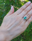 Pear cut halo diamond emerald engagement ring